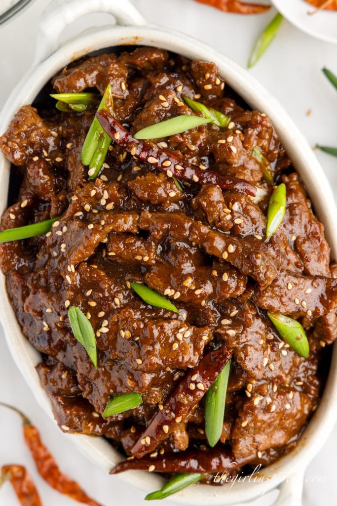 large white serving bowl filled with instant pot mongolian beef