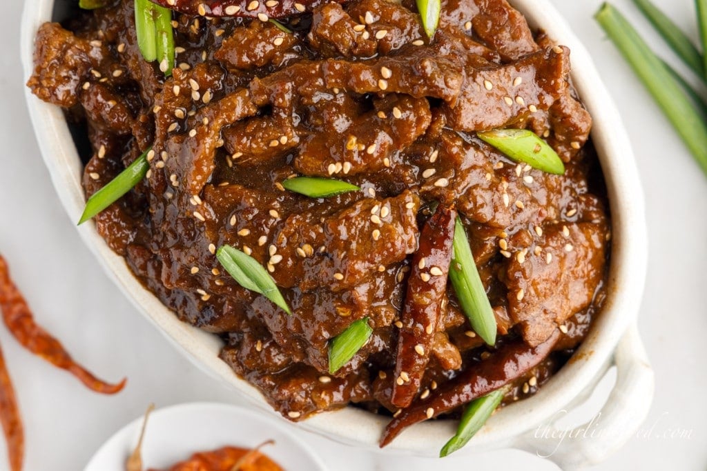 top view of mongolian beef in a white serving dish