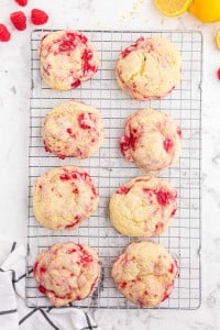 The freshly baked lemon raspberry cookies are placed on a wire rack to cool for 5-10 minutes