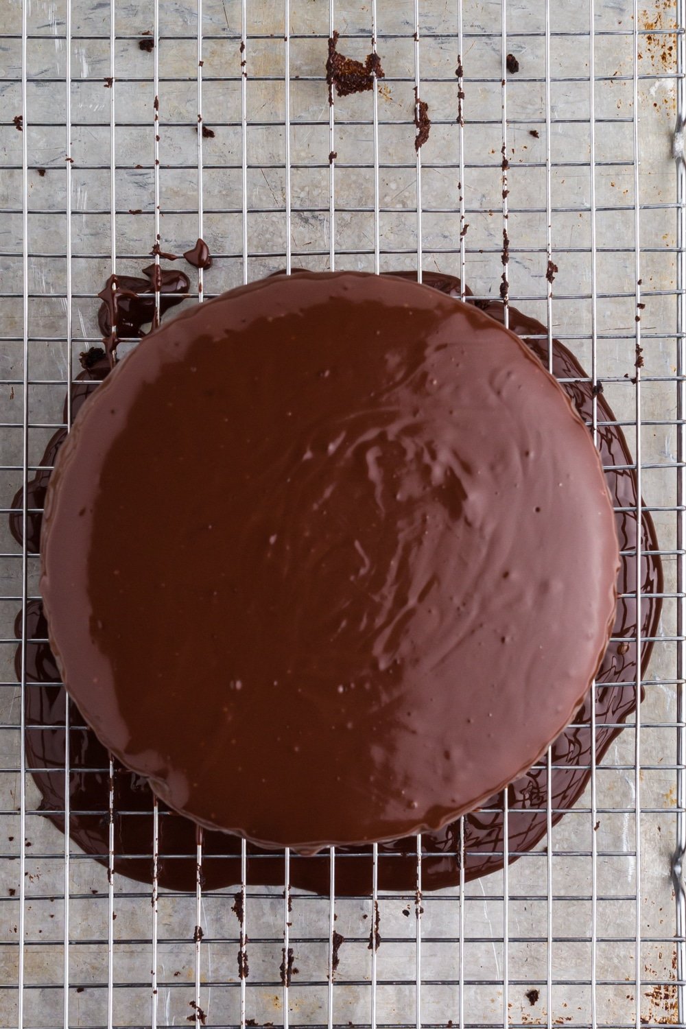 Overhead of chocolate ganache coating the two layer black magic cake.