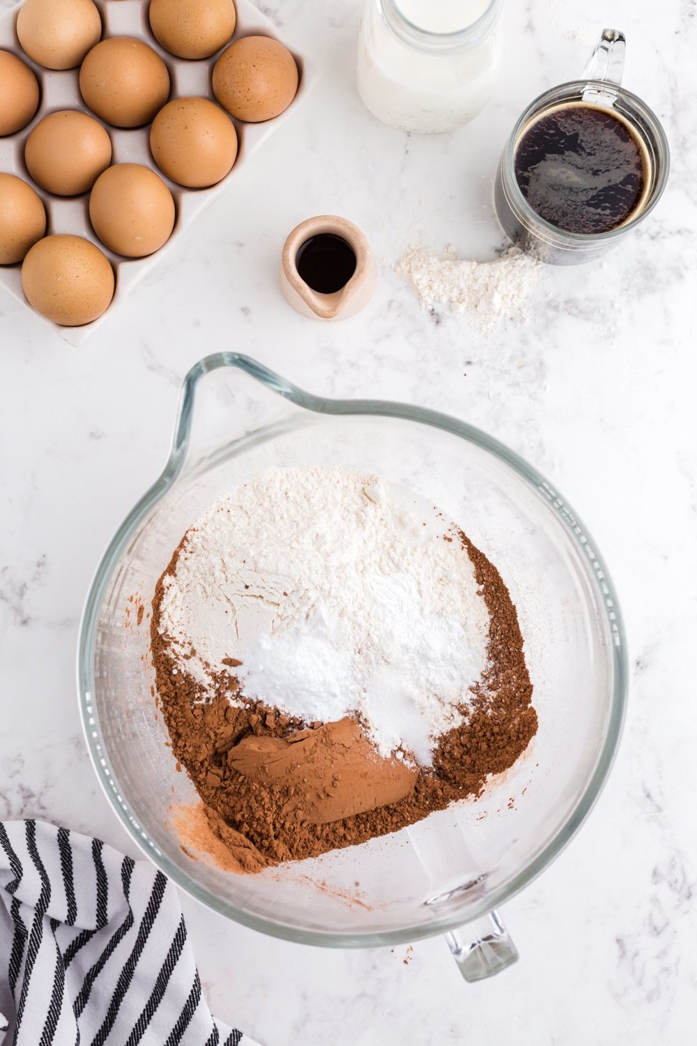 Flour, cocoa powder, and dry ingredients in bowl of a standing mixer.