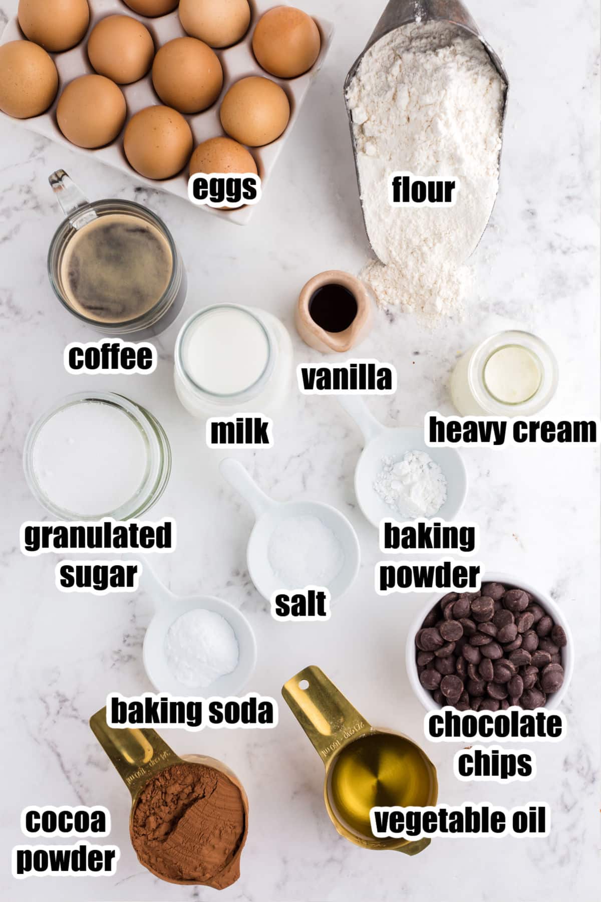 Individual ingredients set out for Black Magic Cake, with text labels.