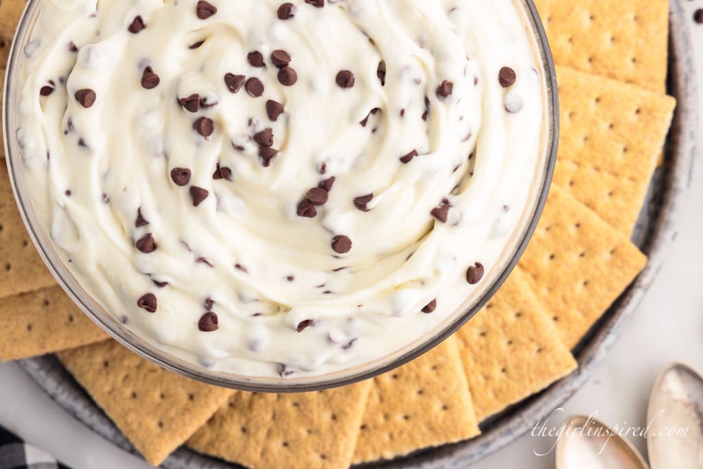 top view of cream cheese booty dip with chocolate chips in a bowl next to graham crackers