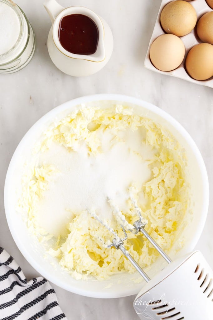 sugar added to mixing bowl of beaten cream cheese.