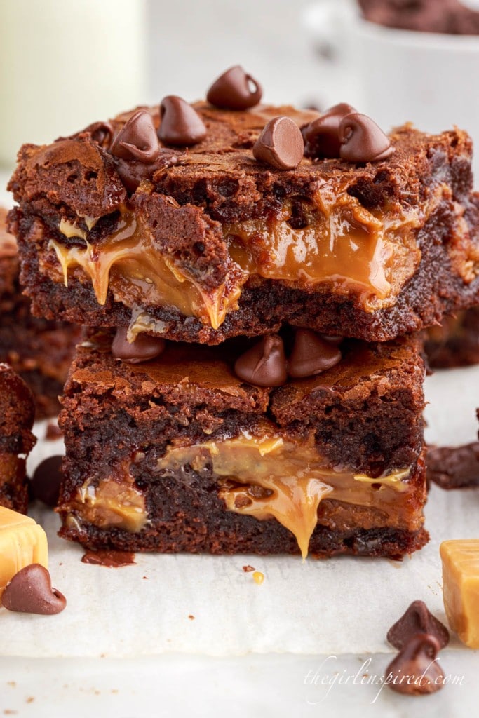 two caramel brownies stacked on top of each other