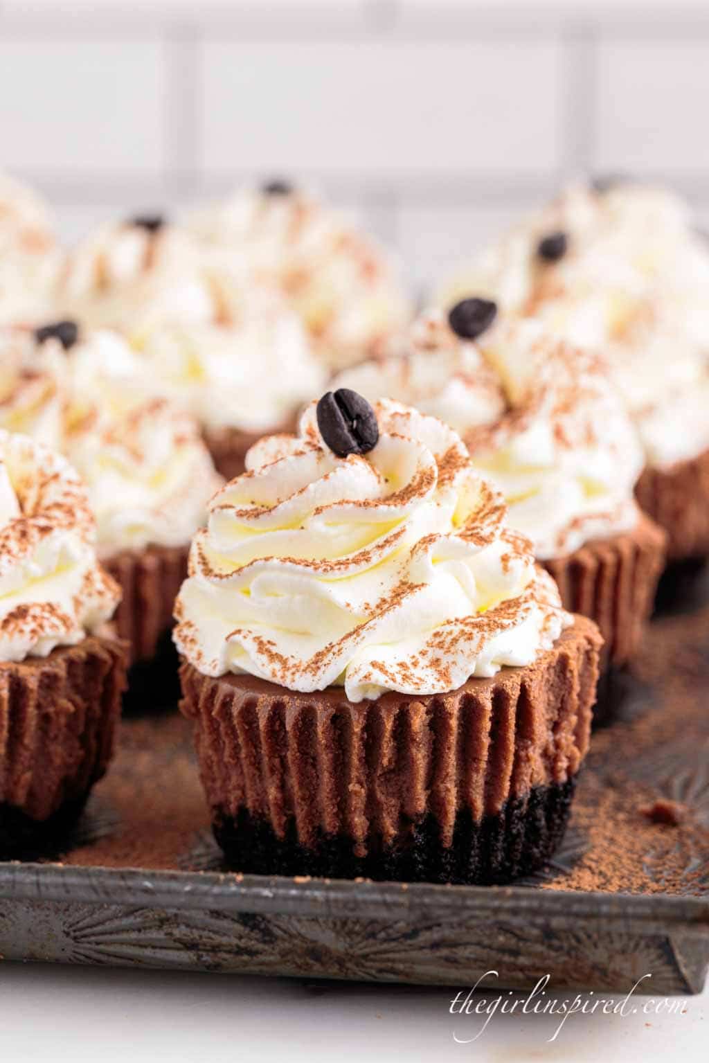 kahlua cheesecakes topped with whipped cream and a coffee bean