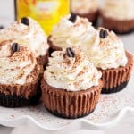 Mini Kahlua cheesecakes on a wavy white cake stand.