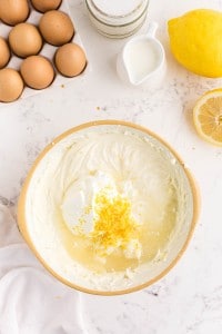 sour cream, heavy cream, lemon zest, and lemon juice added to the cream cheese filling in a medium bowl