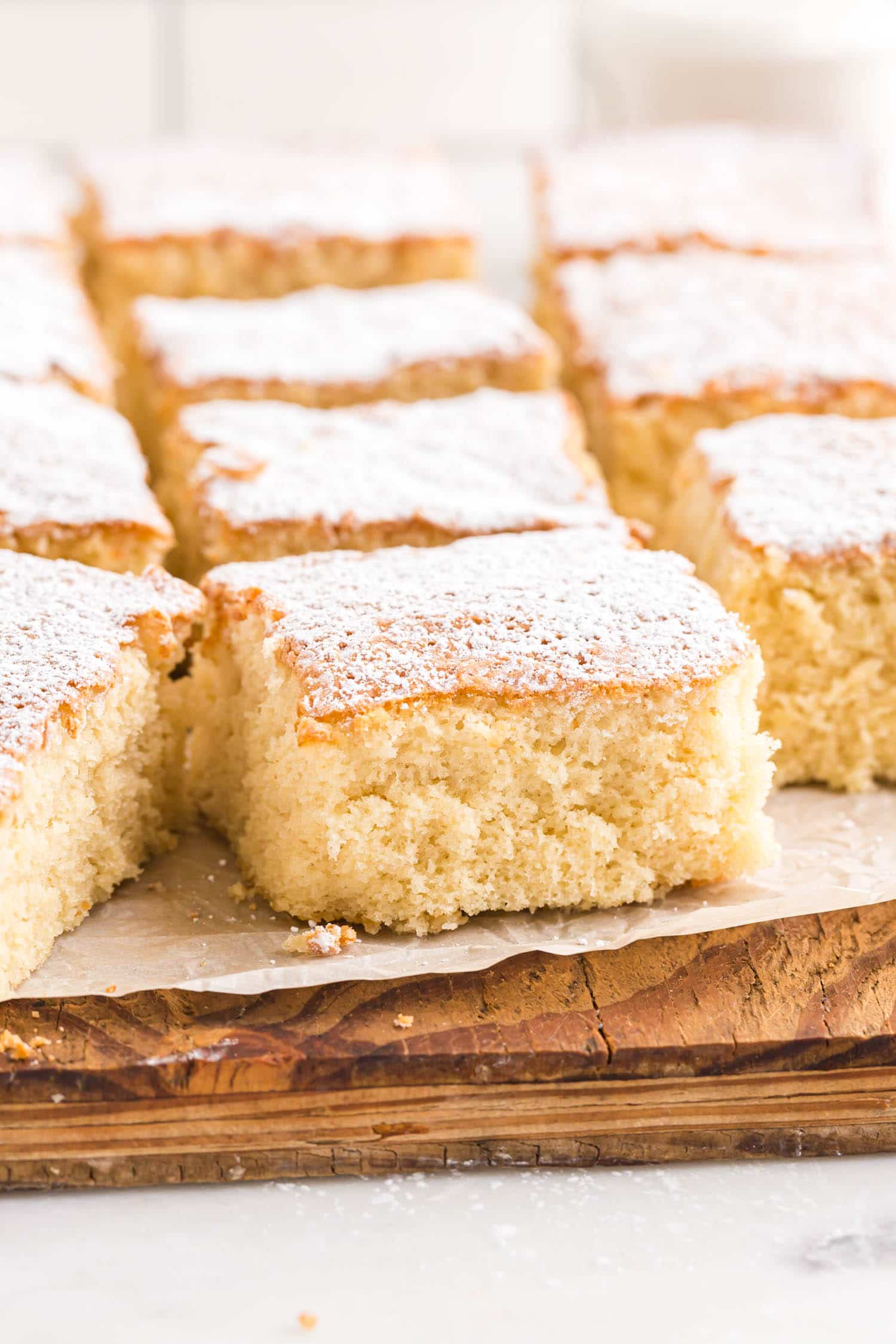milk cake cut into squares dusted with powdered sugar