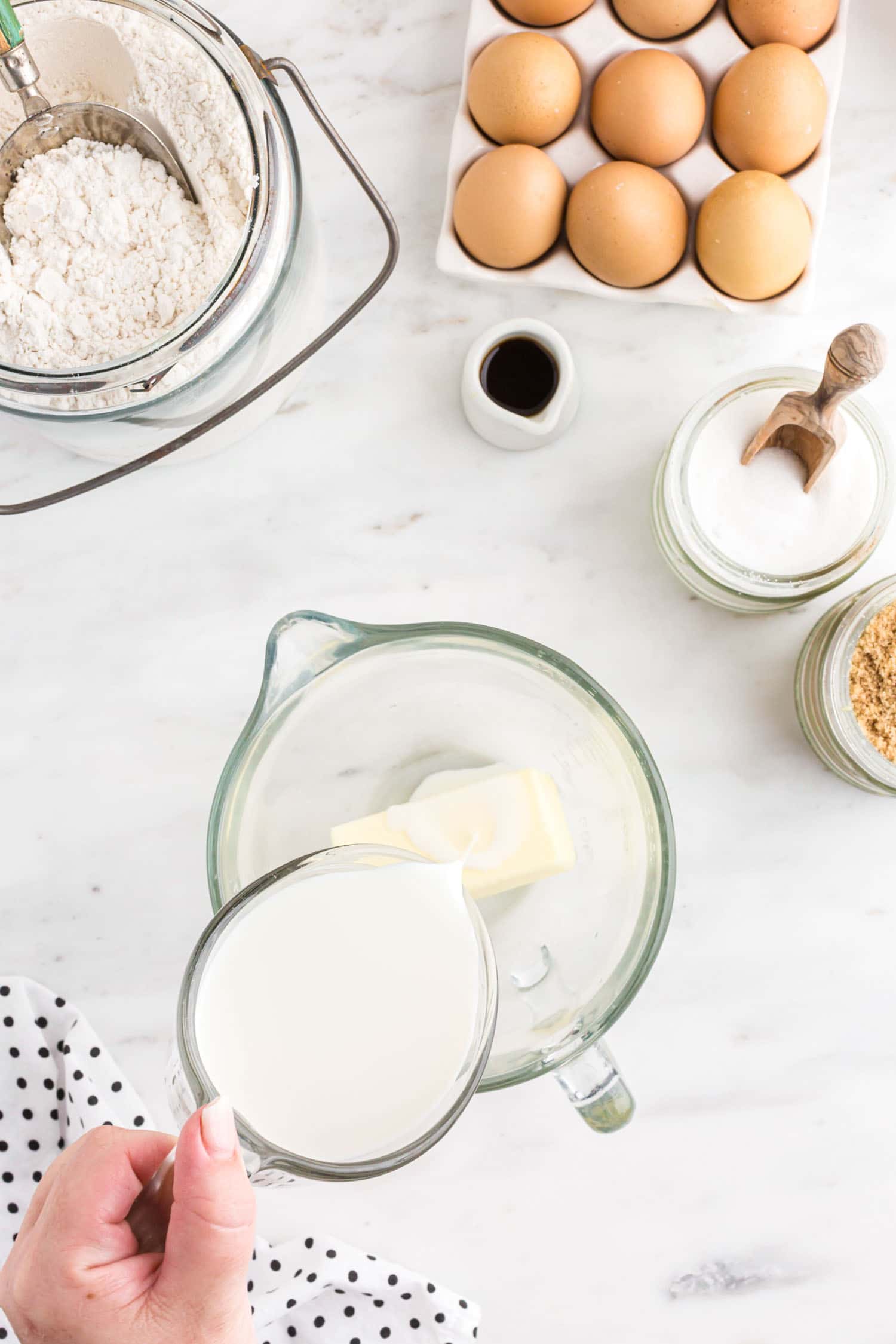 pouring milk into bowl with butter.