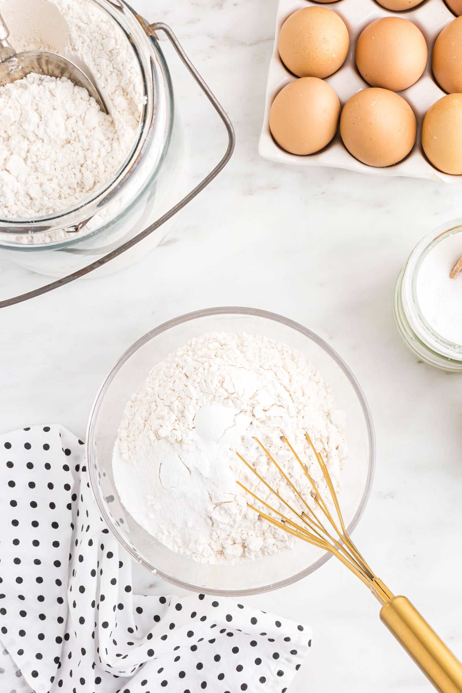 whisking dry ingredients in mixing bowl.