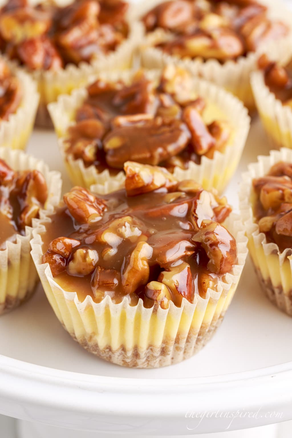 top view of mini pecan cheesecakes on a serving tray in the liners