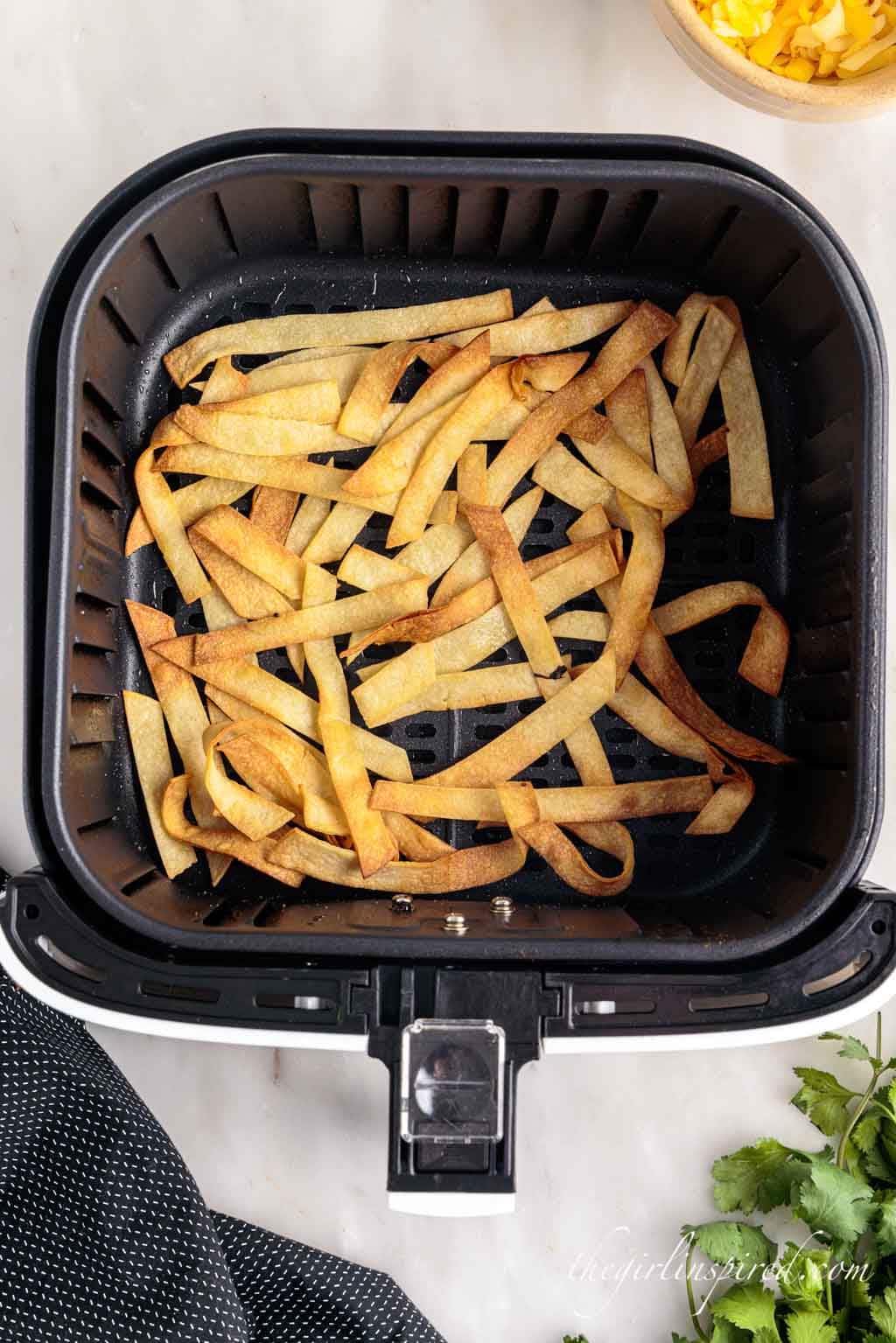 browned and crispy tortilla strips in air fryer.