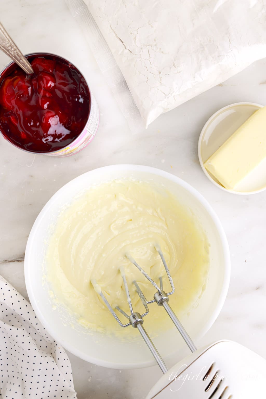 cream cheese mixture beaten together in white mixing bowl.