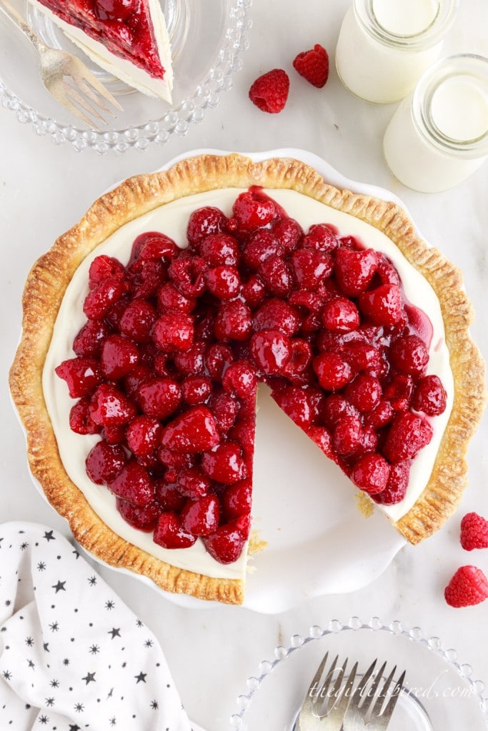 top view of a raspberry cream cheese pie with a slice cut out