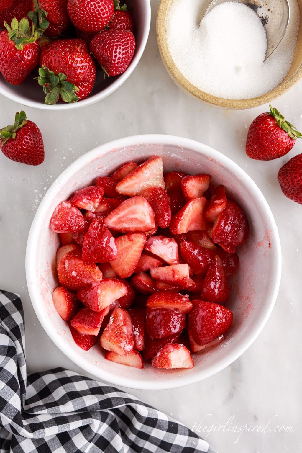 strawberries mixed with sugar in a mixing bowl