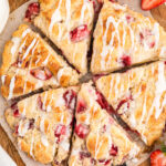 Tops of circle of strawberry scones cut into wedges.