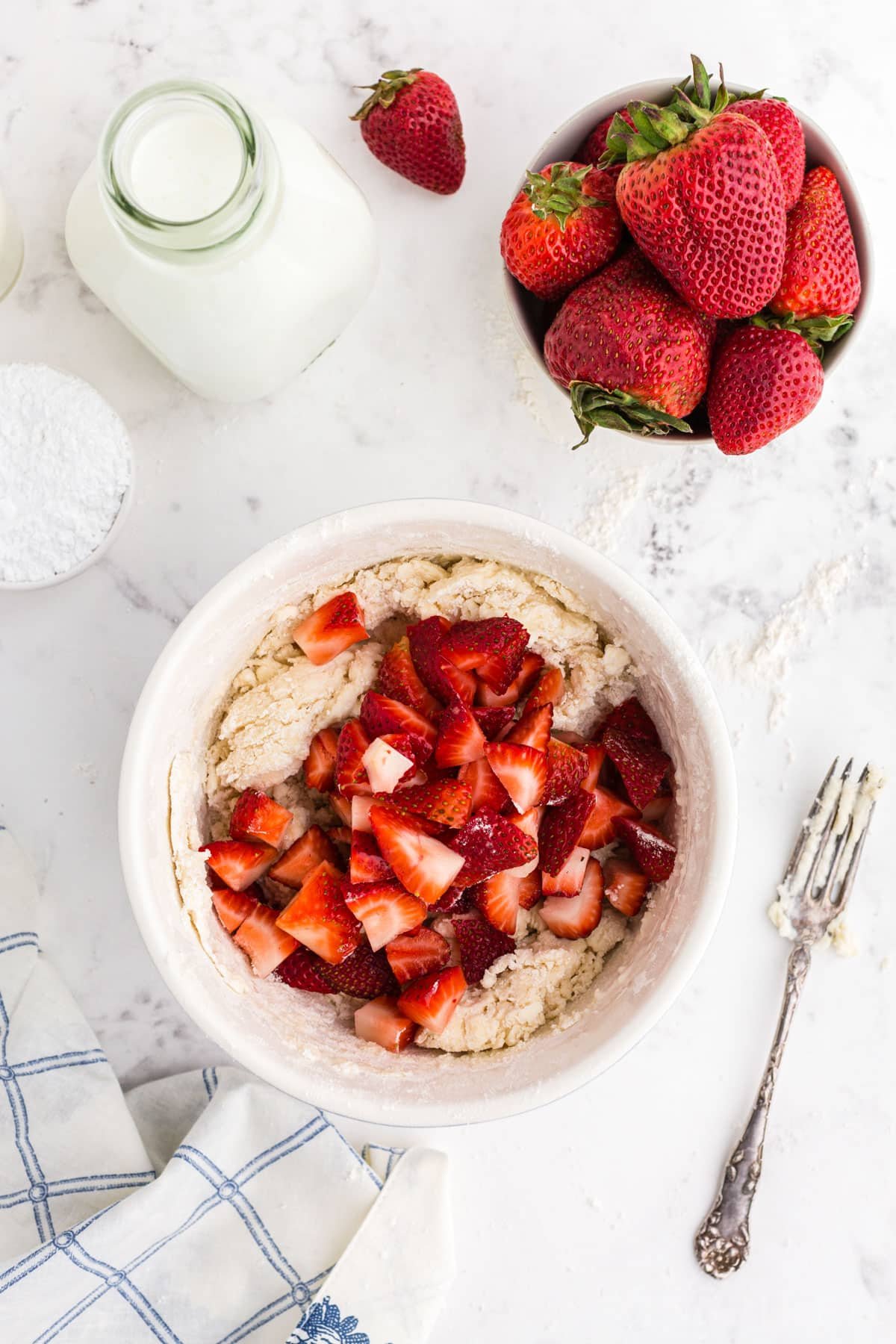 Strawberry pieces in bowl of strawberry scone dough.