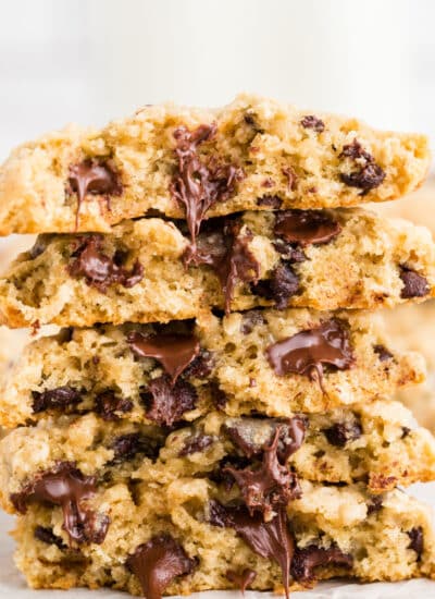 Stack of oatmeal chocolate chip cookies split open to see melted chocolate inside.