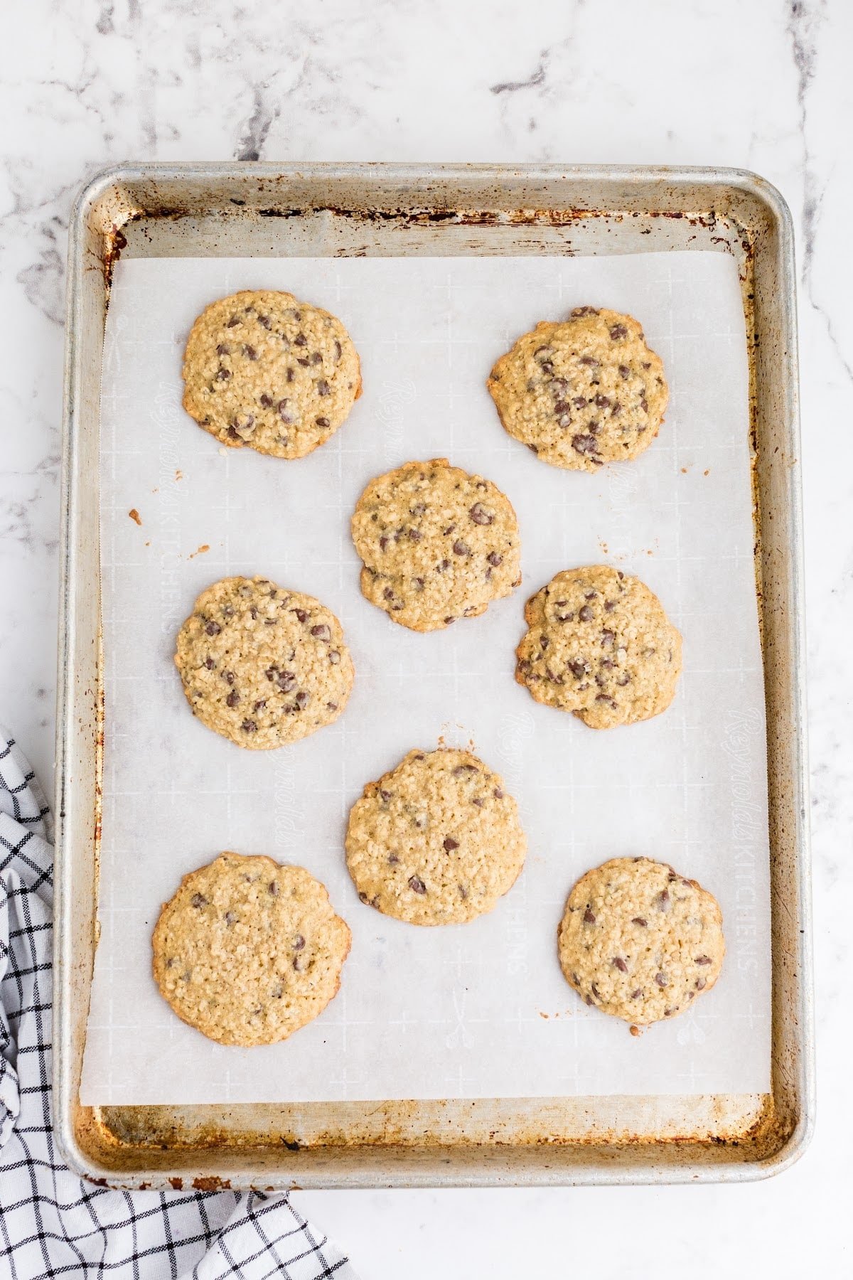 Baked tray of oatmeal chocolate chip cookies.