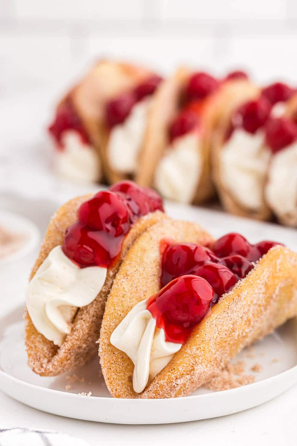 Cherry Cheesecake Tacos on a white plate