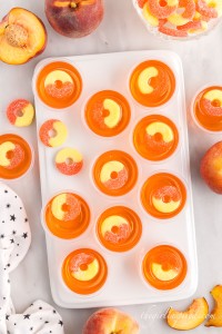 peach jello shots on a serving tray