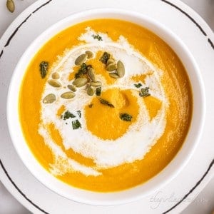Canned pumpkin soup in a white bowl on a plate