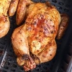 close up of an air fryer cornish hen in an air fryer basket