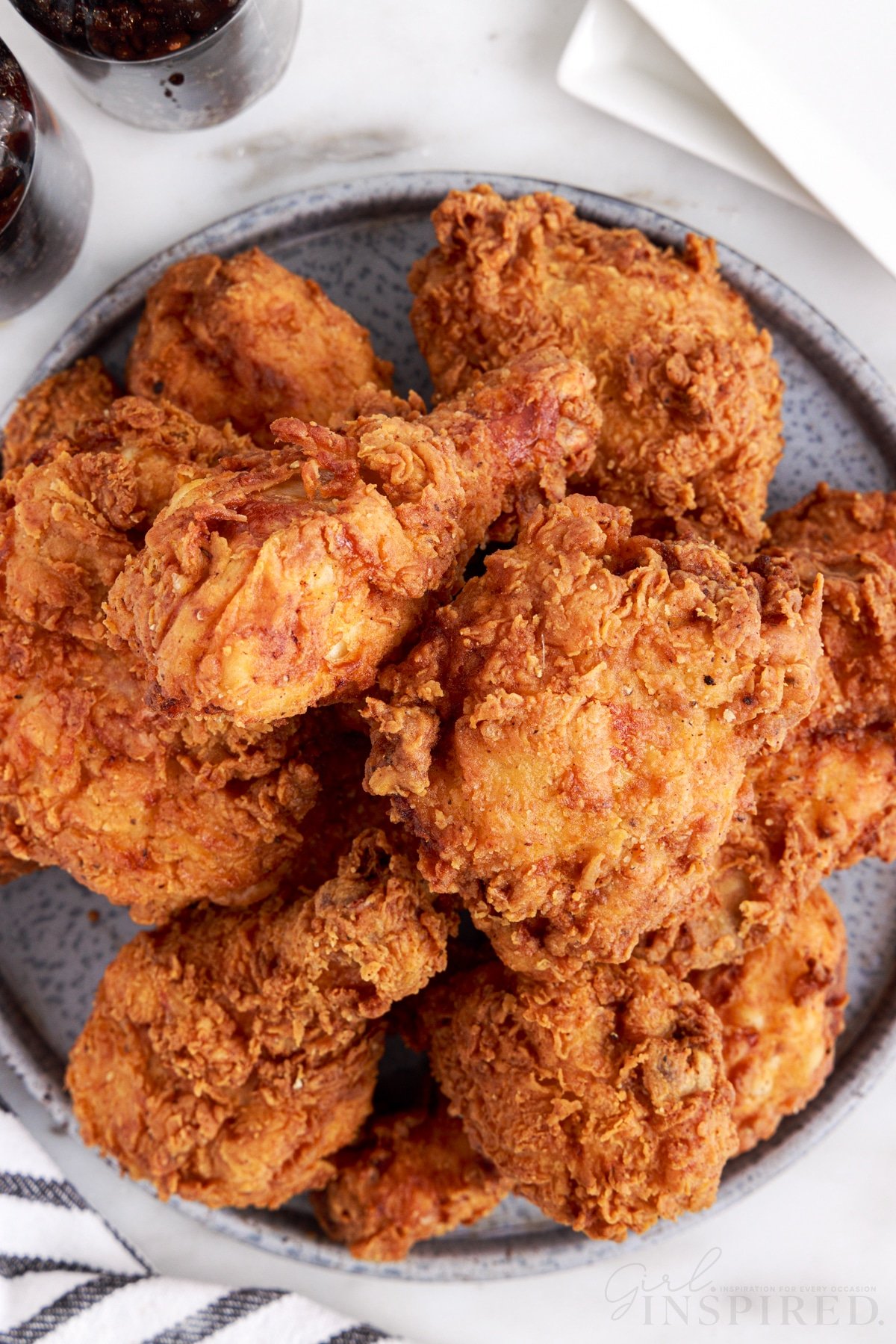 southern fried chicken piled on a grey platter.