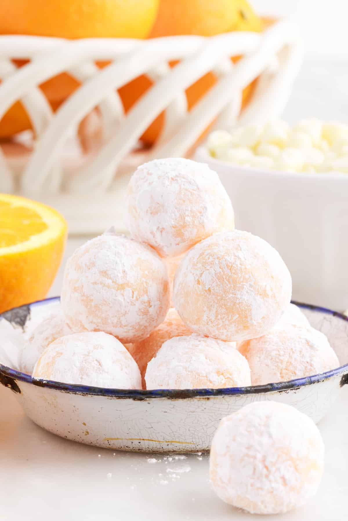 Small tray with stack of orange creamsicle truffles.