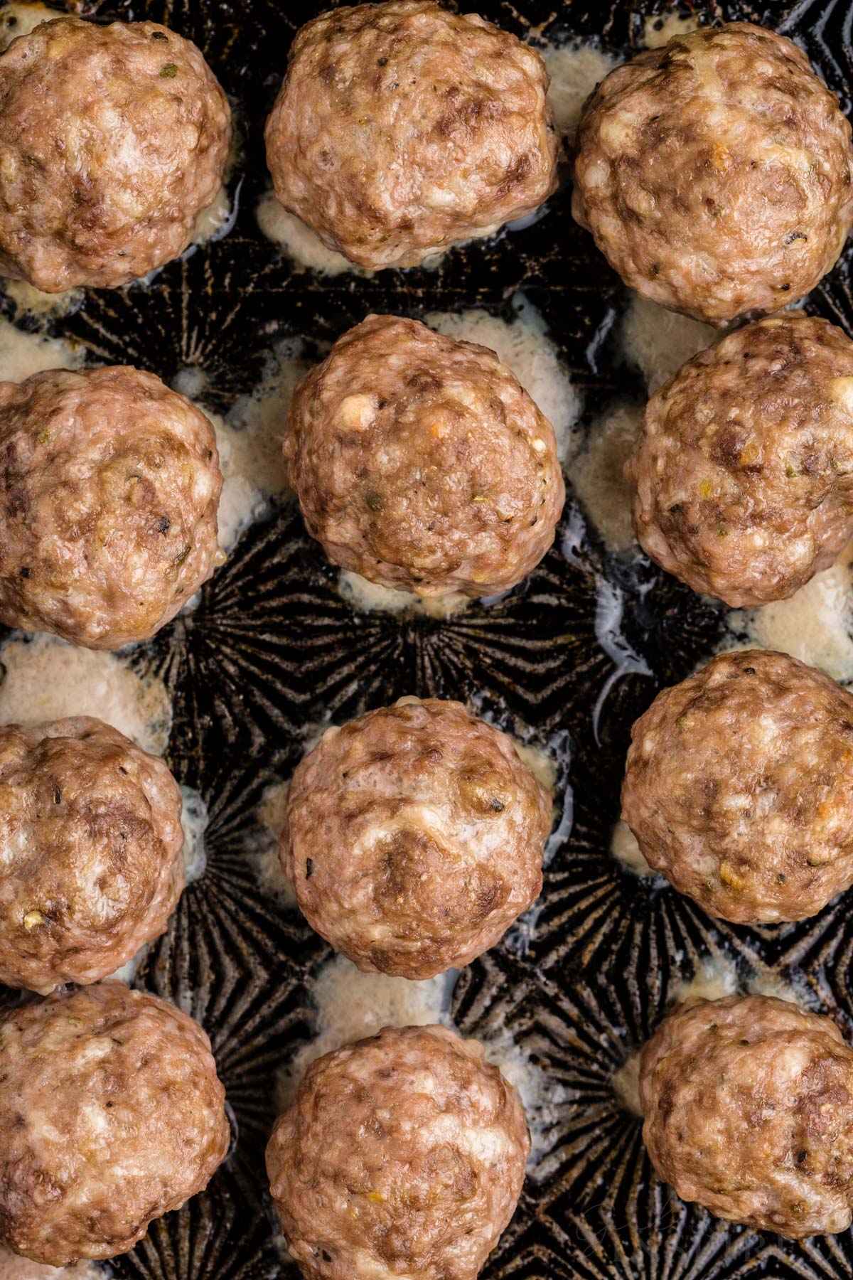 a baking sheet full of oven baked meatballs.