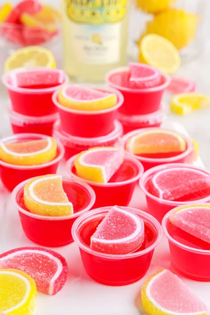pink lemonade jello shots stacked on each other next to the vodka