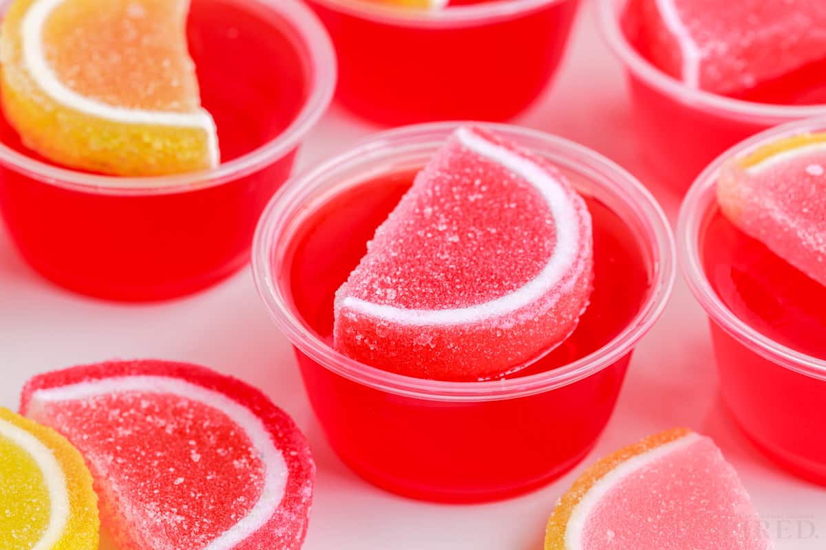 pink lemonade jello shots garnished with gummy candy