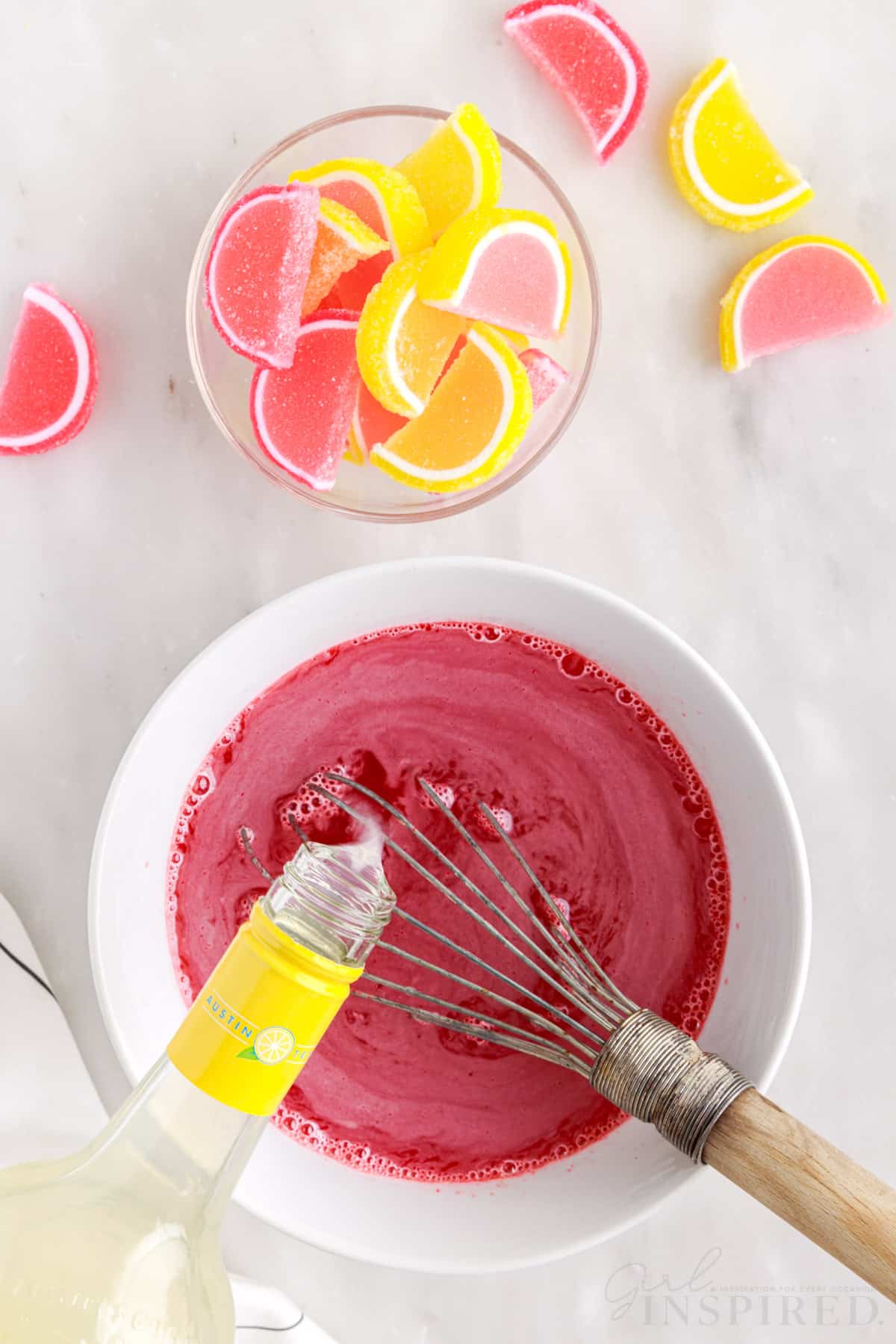 Lemon vodka being poured in the jello mixture, bowl of lemon slice gummies.