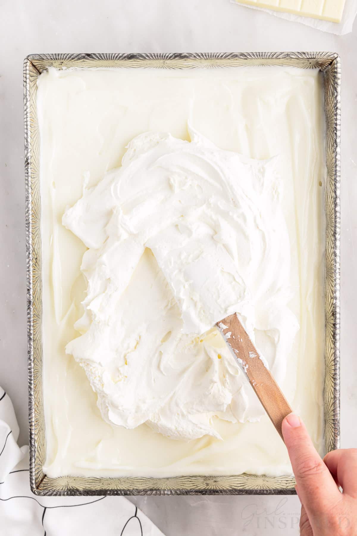 adding the remaining cool whip with a spatula