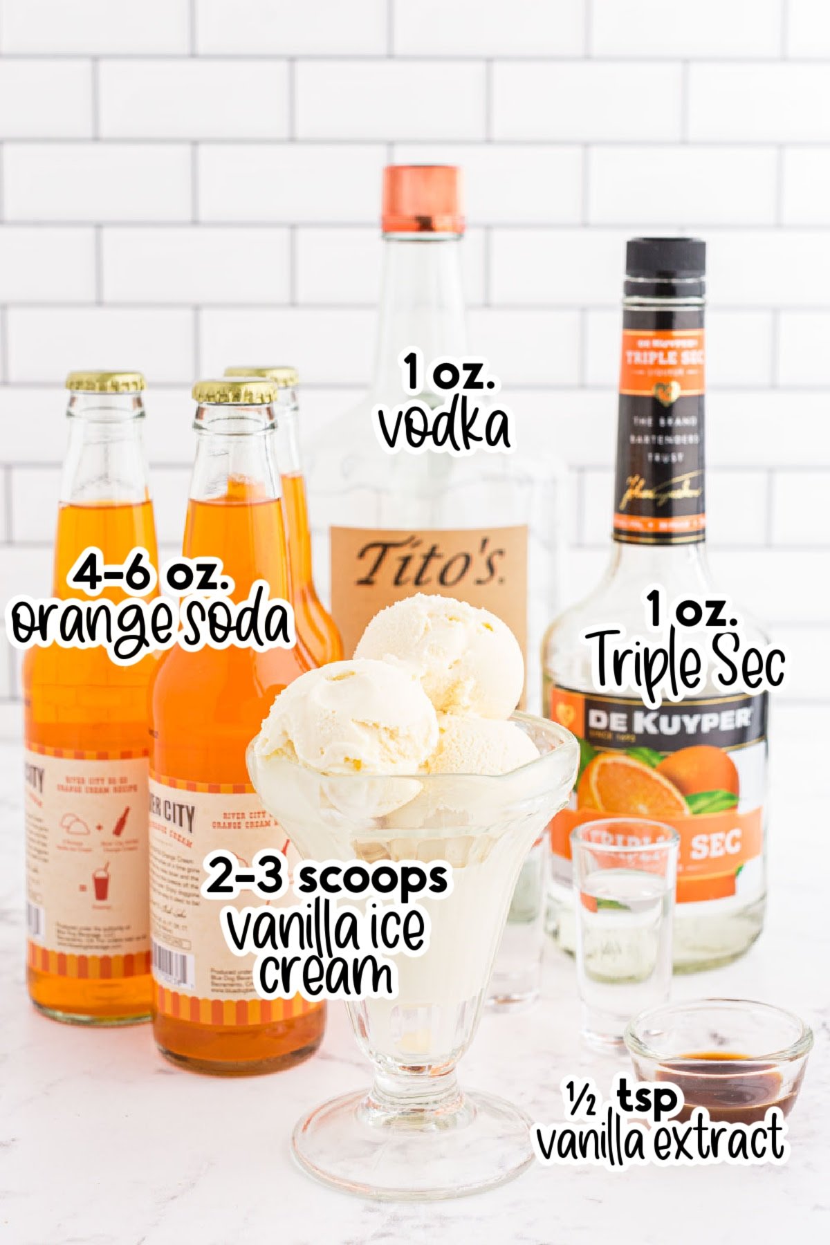 Jars of orange soda, Triple Sec, and vodka and a bowl of vanilla ice cream - text labels for boozy creamsicle float ingredients.