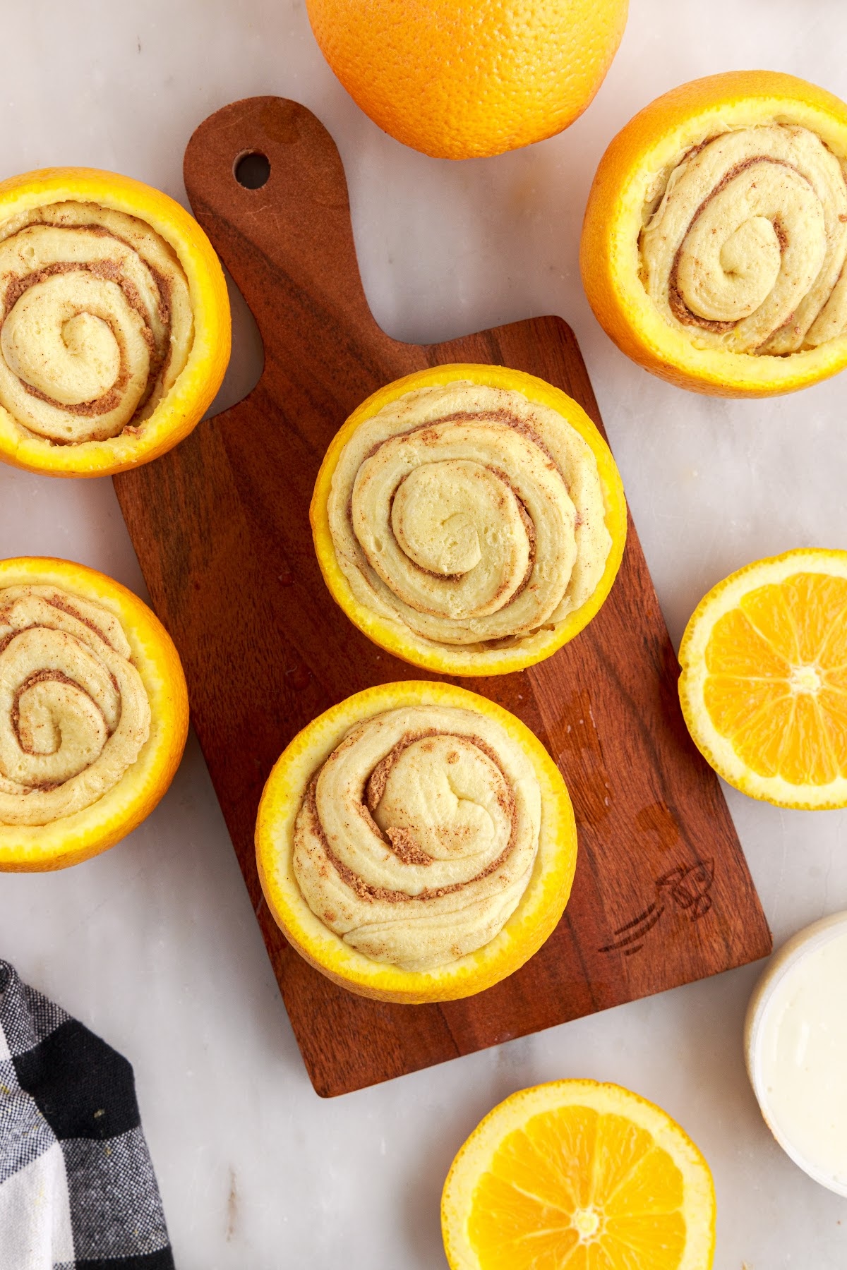 Hollowed out oranges with raw cinnamon rolls stuffed inside.