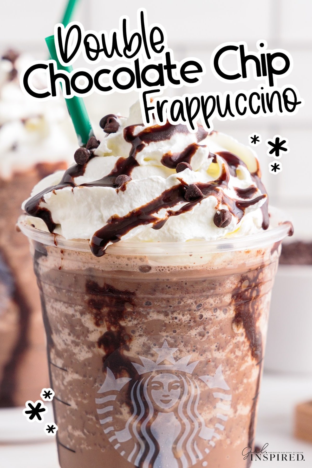 Two homemade double chocolate chip frappuccinos in Starbucks cups with whipped cream, chocolate drizzle and mini chocolate chips on top.