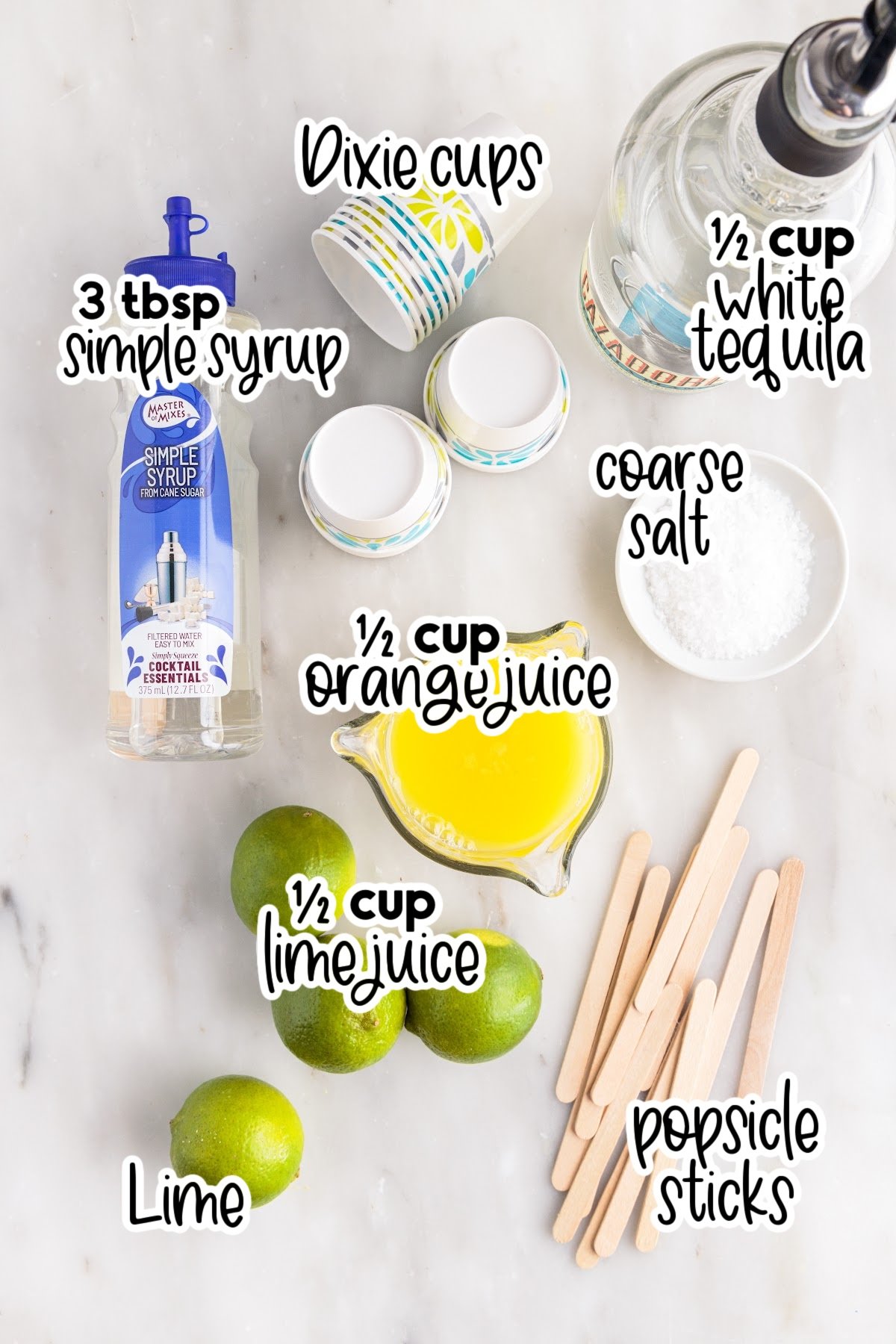 Individual ingredients for margarita popsicles with text and amount labels: limes, popsicle sticks, simple syrup, salt, orange juice, tequila, and Dixie cups.