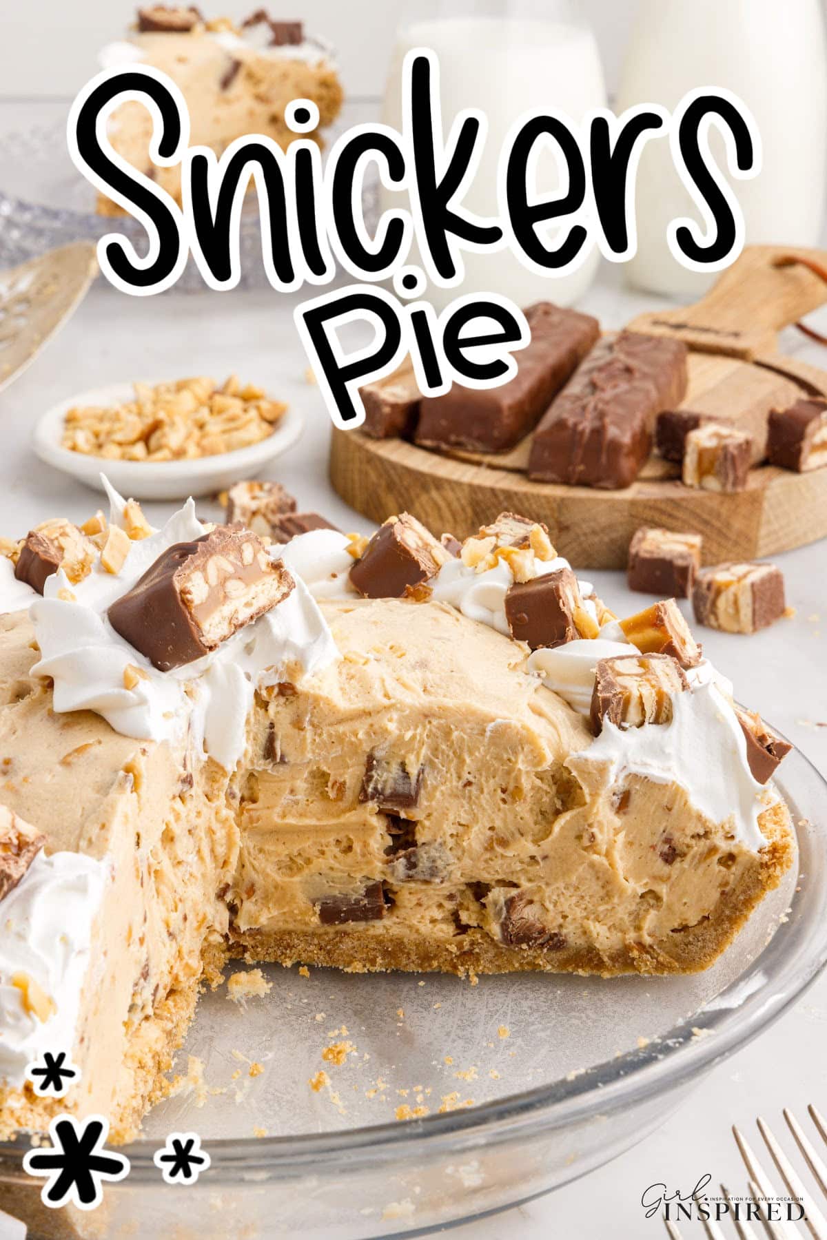 Snickers Pie with a piece missing, showing the inside of the pie, with text overlay.
