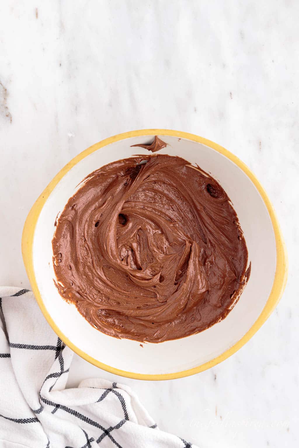 homemade chocolate frosting in a mixing bowl