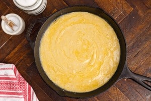 cornbread mixture in a cast iron skillet before baking