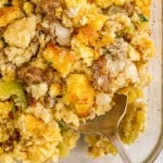 close up of cooked cornbread sausage stuffing with spoon