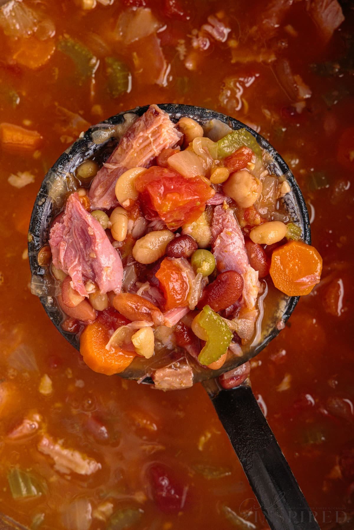 A ladle of 15 bean soup held over instant pot of soup.