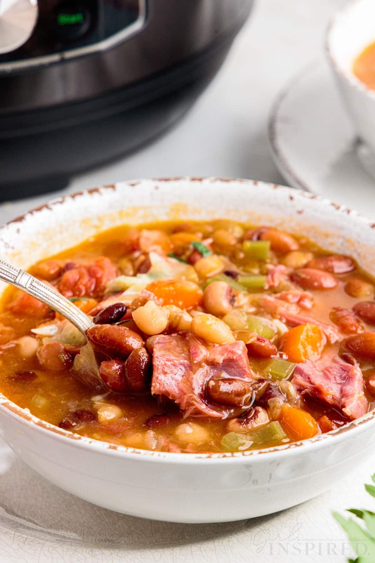 instant pot 15 bean soup in a bowl with a spoon in it