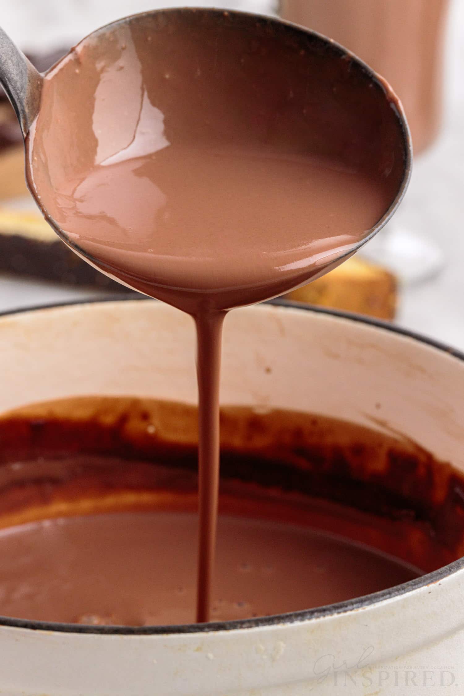 close up of a ladle pouring italian hot chocolate into a sauce pan