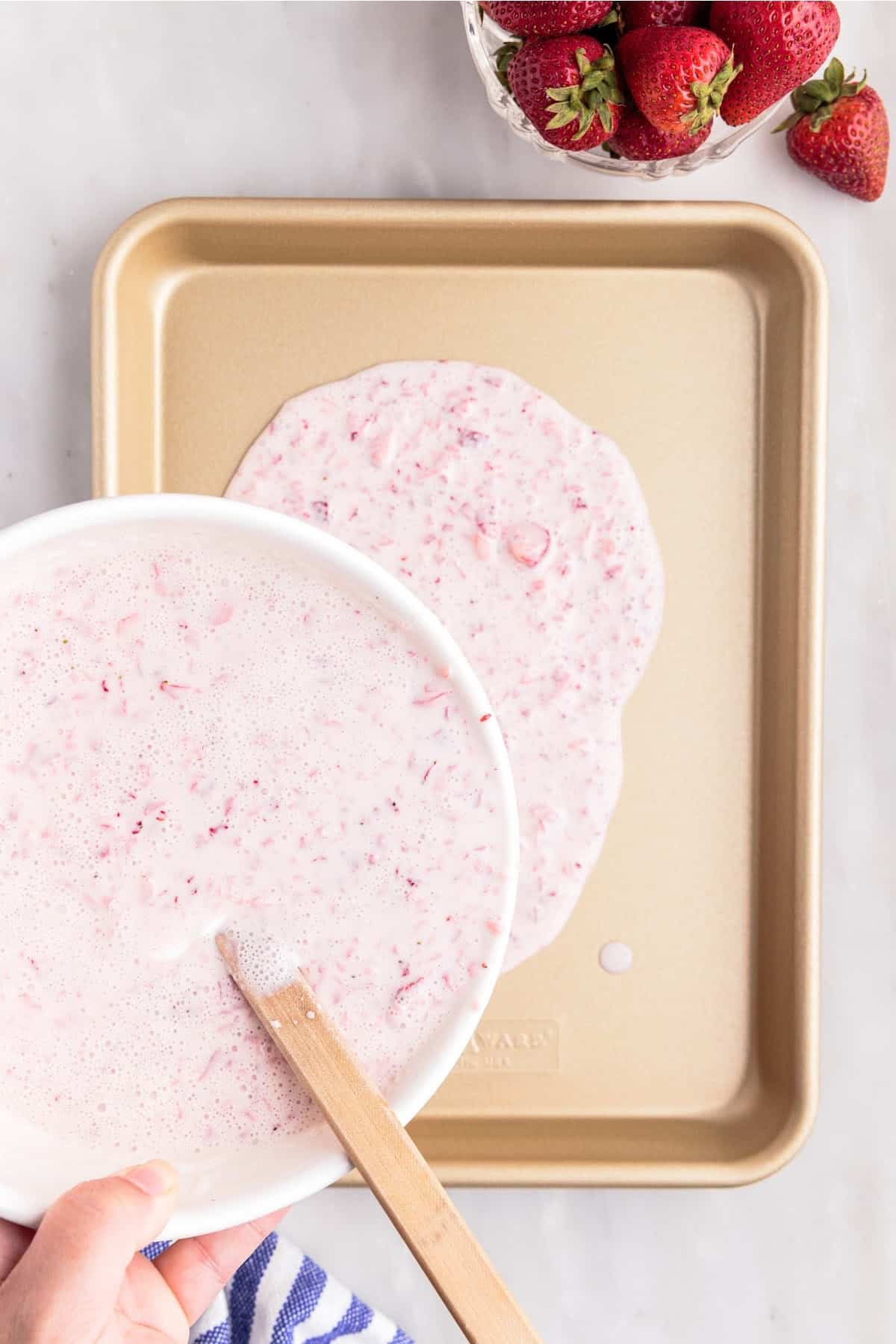 Pouring ice cream mixture onto quarter sheet pan.