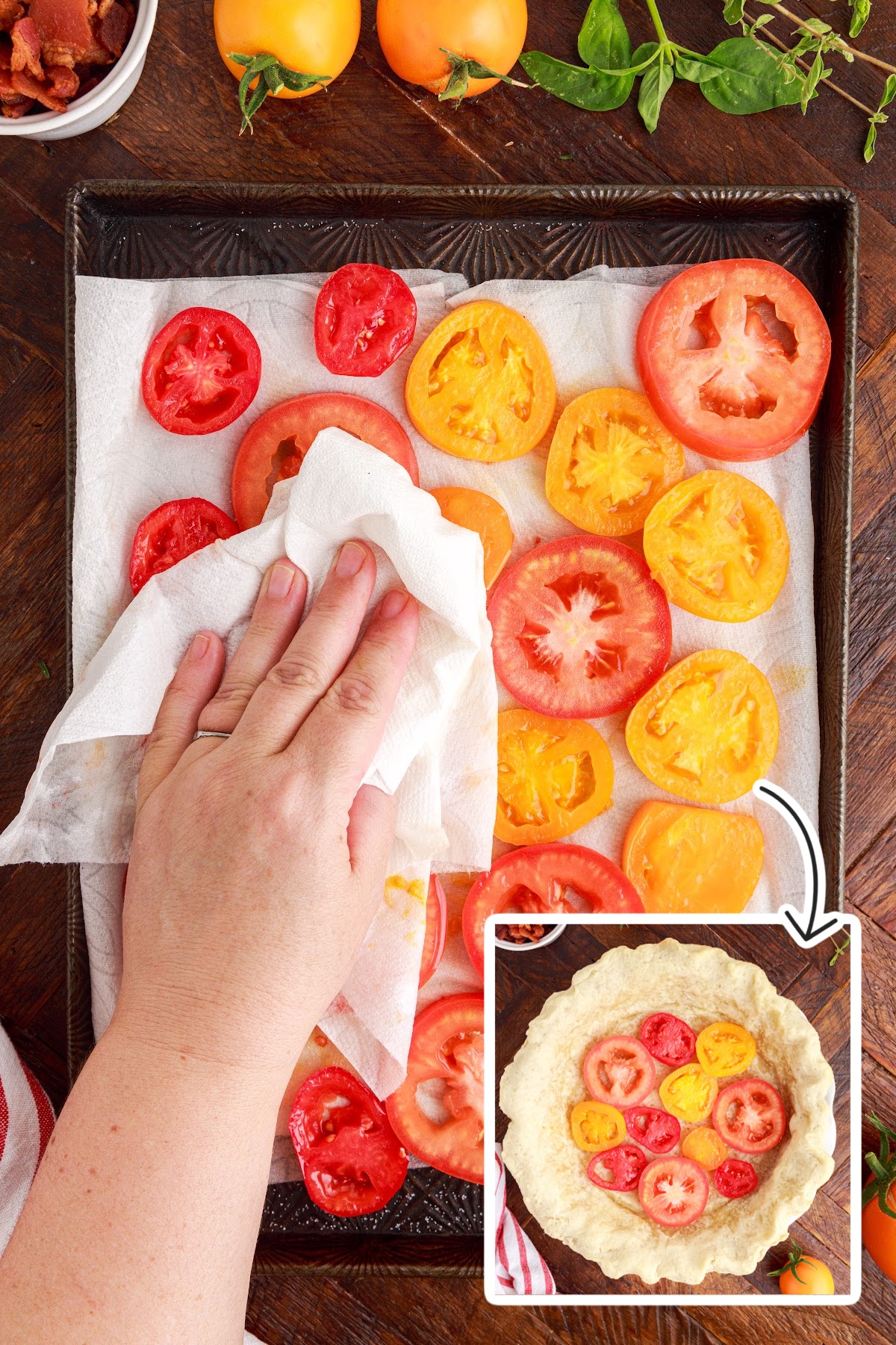 Patting the tomatoes dry with paper towels and placing tomatoes in pie crust.
