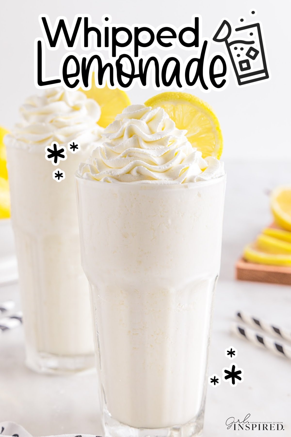 Two glasses of whipped lemonade with lemon wheels and text overlay.