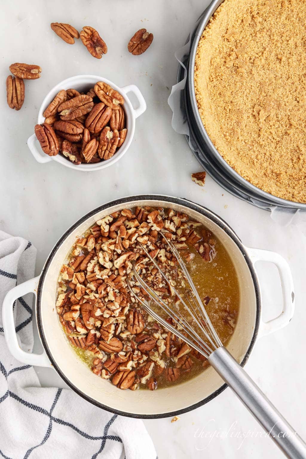 pecans added to butter mixture with a whisk in a sauce pan